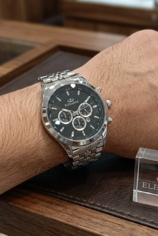 ساعت مچی مردانه الگانس رفرنس 1397G روی مچ دست مردانه، با صفحه مشکی، بند استیل و دیسپلی ELEGANCE در فروشگاه ساعت
